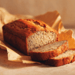 3-ingredient banana bread loaf sliced on parchment paper